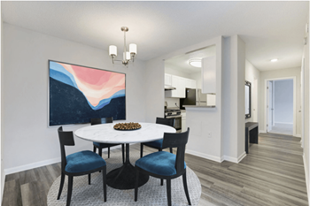 A dining room with a white table and blue chairs